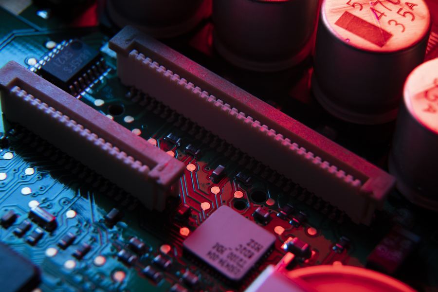 Close-up of a circuit board with expansion slots and capacitors